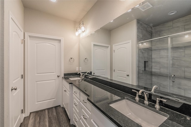 bathroom featuring vanity, hardwood / wood-style flooring, and an enclosed shower