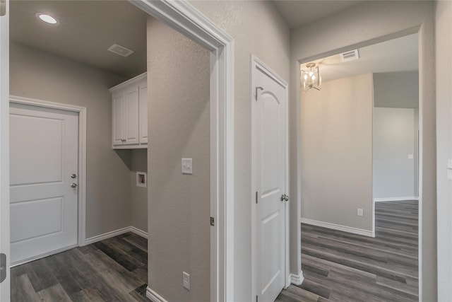 clothes washing area with cabinets, hookup for a washing machine, and dark hardwood / wood-style floors