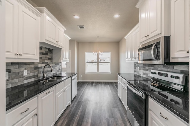 kitchen with sink, appliances with stainless steel finishes, and white cabinetry