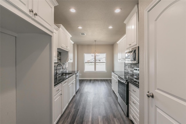 kitchen with sink, white cabinets, stainless steel appliances, and tasteful backsplash