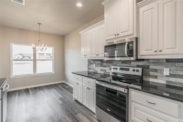 kitchen featuring stainless steel appliances, backsplash, a chandelier, white cabinets, and dark hardwood / wood-style flooring