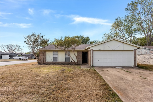 single story home featuring a garage and a front lawn