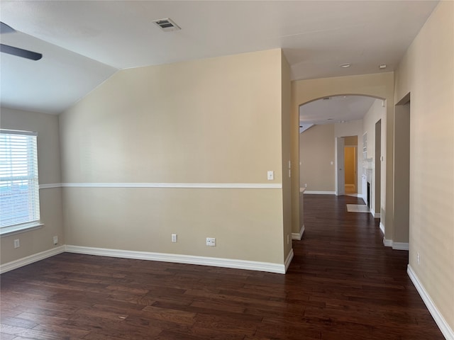 unfurnished room with lofted ceiling, ceiling fan, and dark hardwood / wood-style flooring