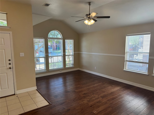 foyer entrance with a wealth of natural light and hardwood / wood-style floors