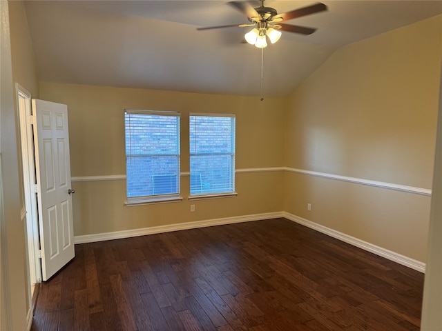 spare room with dark hardwood / wood-style floors, ceiling fan, and vaulted ceiling