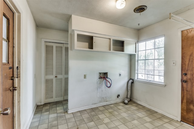 clothes washing area with hookup for a gas dryer, light tile patterned floors, washer hookup, and electric dryer hookup