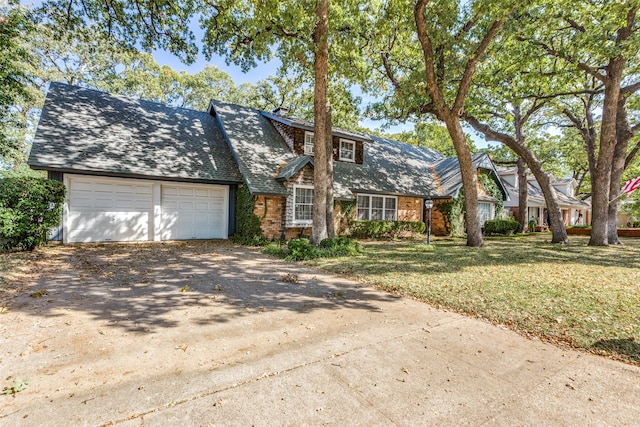 view of front of home with a front lawn and a garage