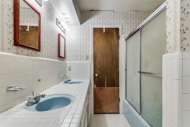 bathroom with vanity, bath / shower combo with glass door, and tile patterned floors