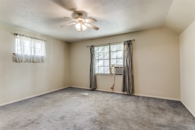 carpeted spare room with ceiling fan, a textured ceiling, and lofted ceiling