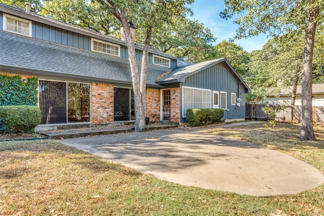 view of front property featuring a front yard and a patio