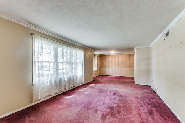 spare room featuring crown molding, carpet flooring, and a textured ceiling