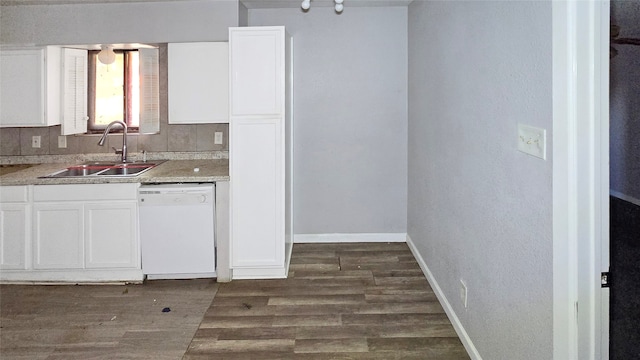 kitchen featuring sink, dishwasher, white cabinetry, and dark hardwood / wood-style floors