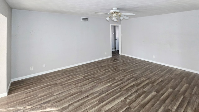 empty room with dark wood-type flooring and ceiling fan