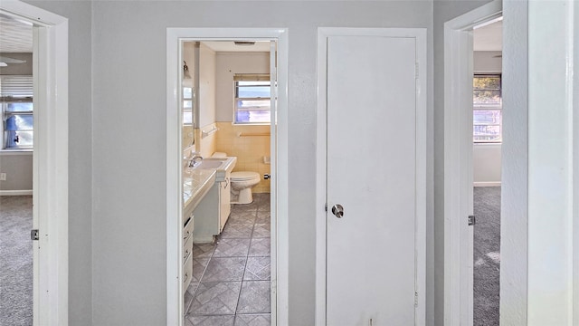 bathroom featuring vanity, toilet, and a wealth of natural light