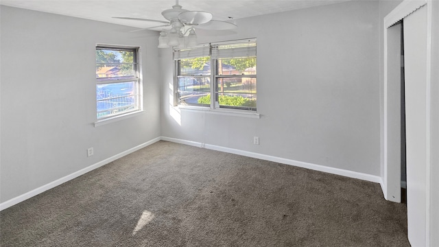 carpeted spare room with ceiling fan