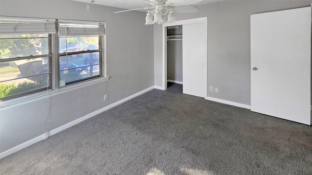 unfurnished bedroom with dark carpet, a closet, and ceiling fan