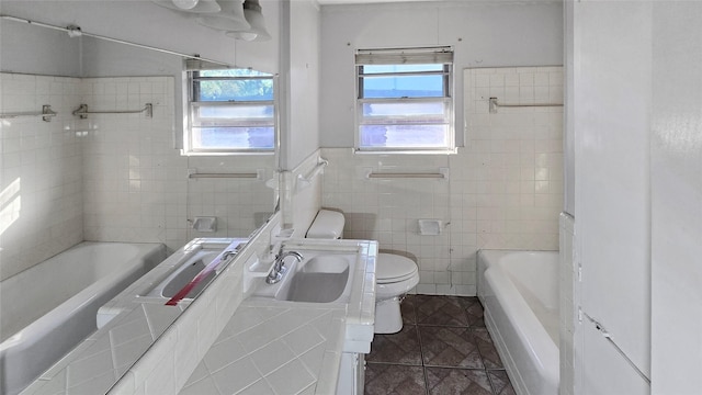 5706 Rocky Ridge Rd, Dallas, TX 75241 - bathroom with tile walls, a bath, toilet, vanity, and wainscoting