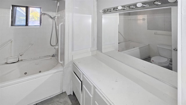 full bathroom featuring toilet, tiled shower / bath combo, and vanity