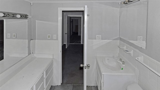 bathroom with vanity, tile patterned floors, and tile walls