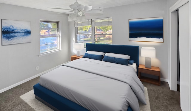 bedroom featuring dark carpet and ceiling fan