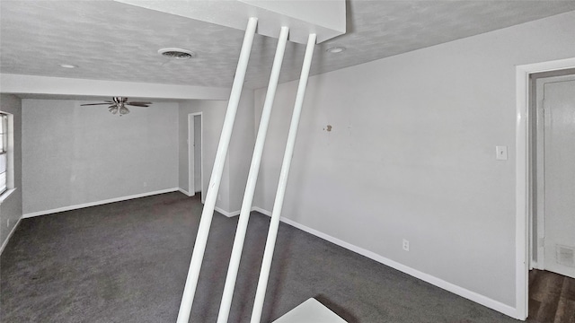 carpeted spare room featuring a textured ceiling and ceiling fan