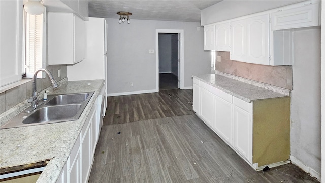 kitchen with sink, white cabinetry, and dark hardwood / wood-style floors