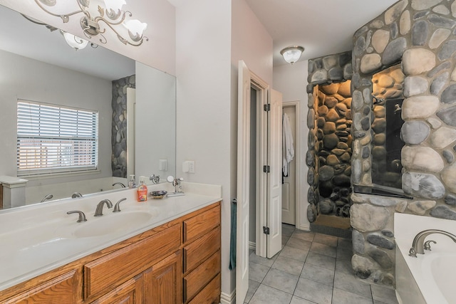 bathroom with a bathing tub, vanity, and tile patterned floors