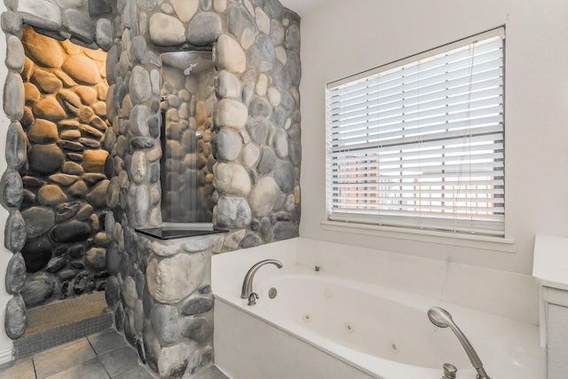 bathroom with tile patterned floors and a tub