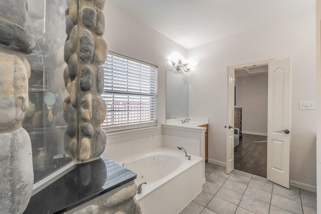 bathroom with tile patterned floors, vanity, and a bath