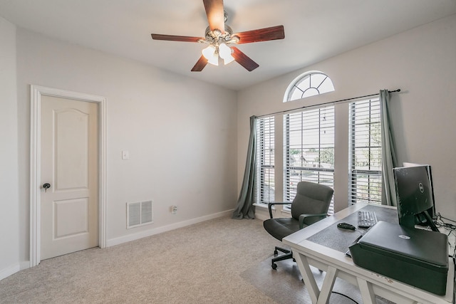 carpeted office featuring ceiling fan