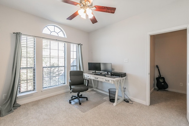 carpeted office with ceiling fan and a healthy amount of sunlight