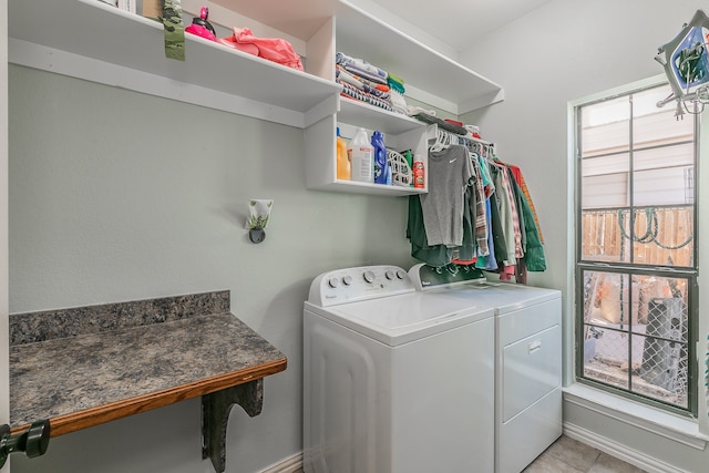 clothes washing area featuring washer and dryer and light tile patterned floors