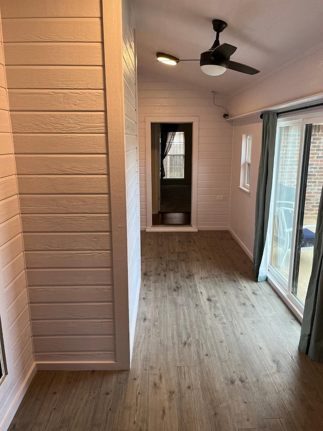 interior space with wood-type flooring and wood walls