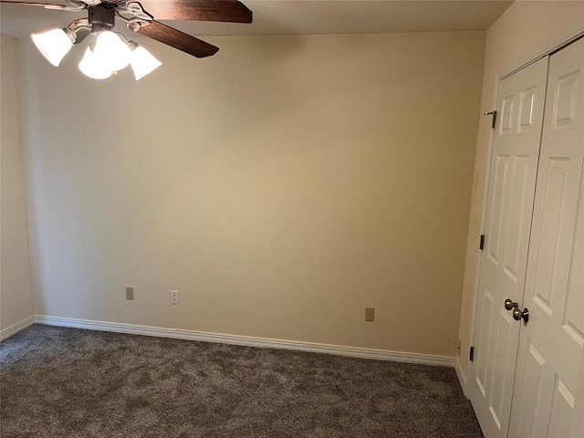 unfurnished room with dark carpet and ceiling fan