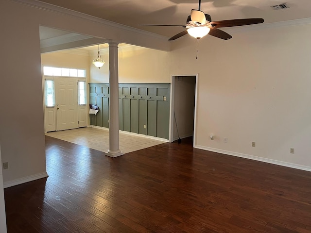 unfurnished room featuring hardwood / wood-style flooring, ornamental molding, ceiling fan, and ornate columns