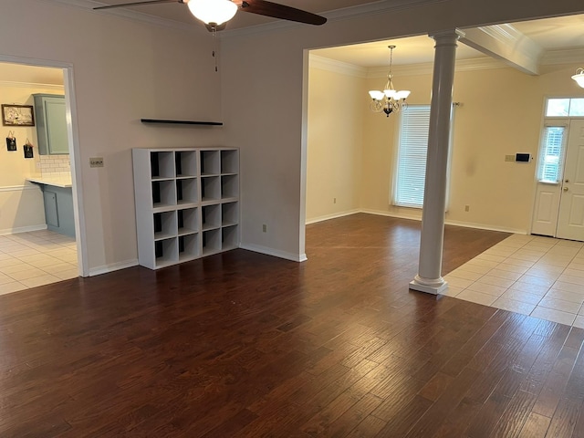 unfurnished living room featuring crown molding, ceiling fan with notable chandelier, decorative columns, and light hardwood / wood-style flooring