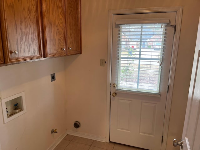 washroom featuring cabinets, electric dryer hookup, washer hookup, and light tile patterned floors