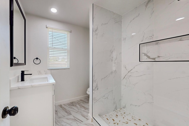 bathroom featuring vanity, toilet, and a tile shower