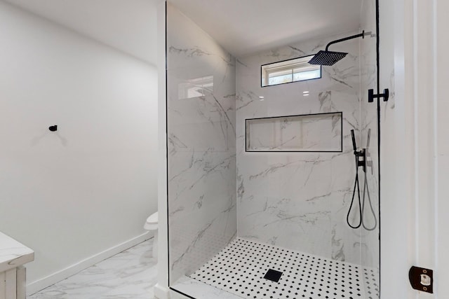 bathroom featuring toilet, vanity, and a tile shower