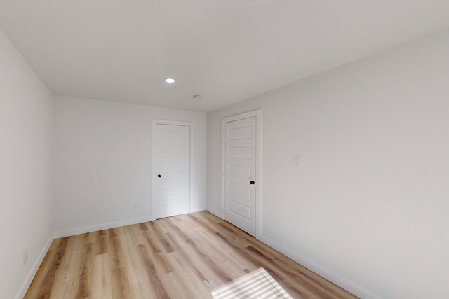 unfurnished room with light wood-type flooring