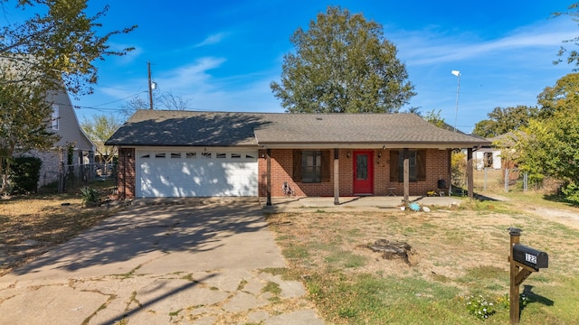 ranch-style home featuring covered porch and a garage