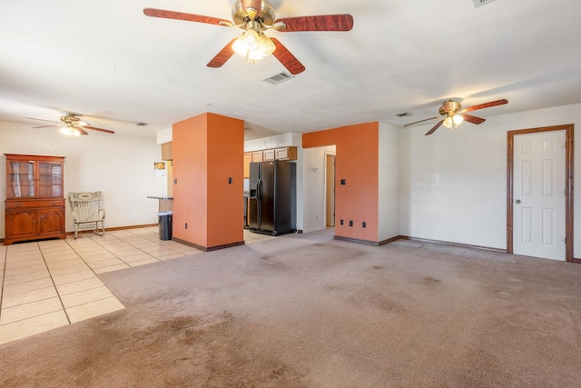 unfurnished living room featuring light colored carpet and ceiling fan