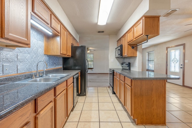 kitchen featuring sink, black appliances, decorative backsplash, and light tile patterned floors