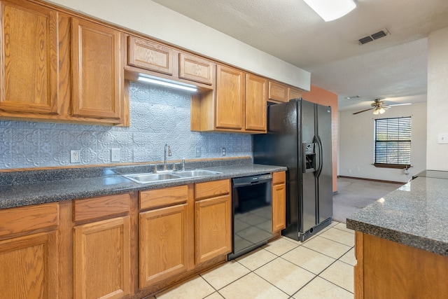 kitchen featuring light tile patterned floors, black appliances, sink, and backsplash