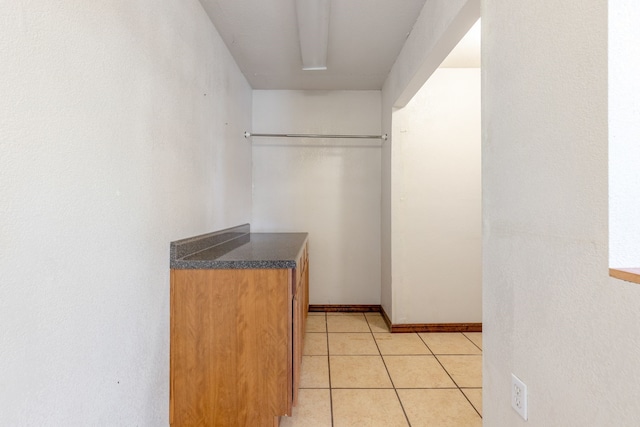 walk in closet featuring light tile patterned floors