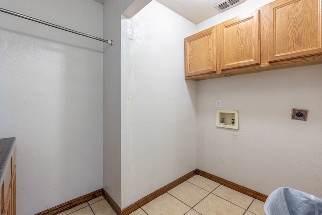 laundry area with cabinets, hookup for an electric dryer, light tile patterned flooring, and washer hookup