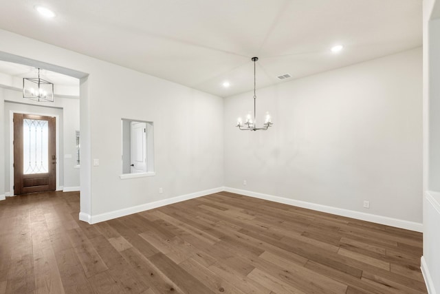 interior space featuring dark hardwood / wood-style floors and an inviting chandelier