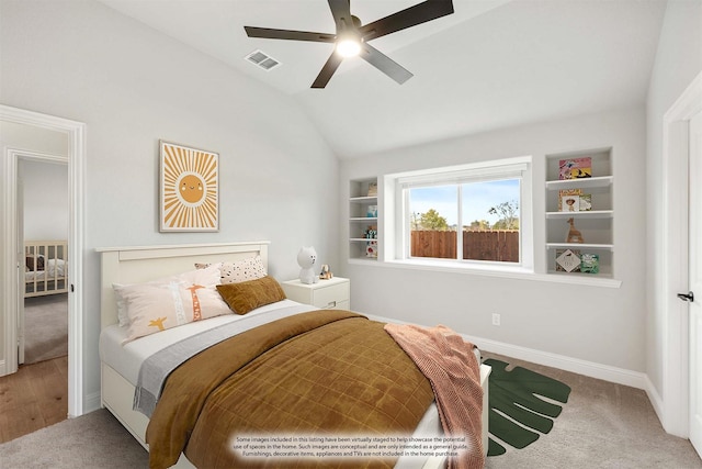 carpeted bedroom featuring ceiling fan and vaulted ceiling