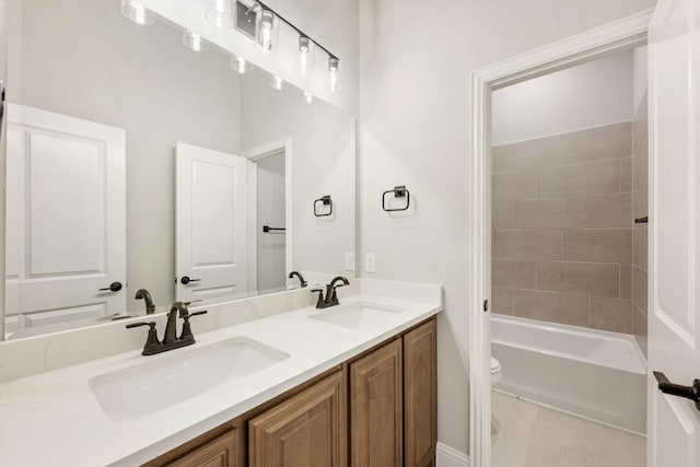 full bathroom featuring vanity, toilet, and tiled shower / bath