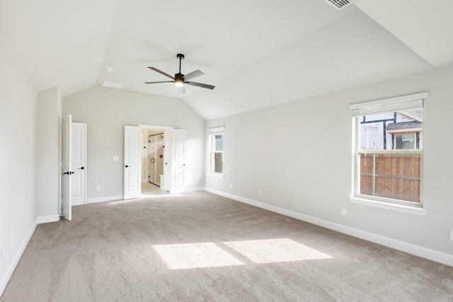 unfurnished bedroom featuring ceiling fan, lofted ceiling, and light carpet